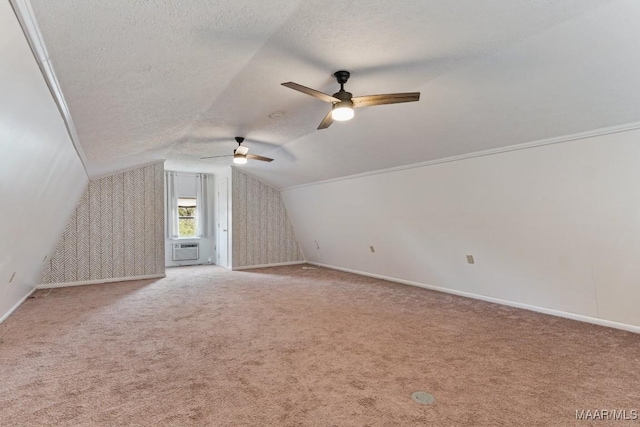 bonus room featuring baseboards, carpet floors, a textured ceiling, and vaulted ceiling