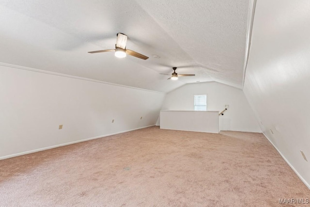 bonus room with light carpet, a textured ceiling, and lofted ceiling