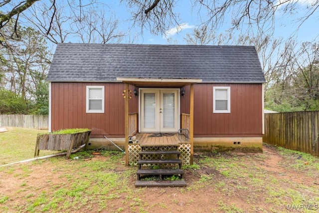 view of outbuilding featuring french doors, an outdoor structure, and fence private yard