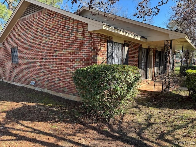 view of home's exterior with brick siding