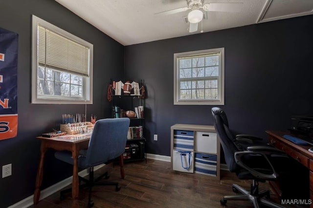 office area with baseboards, a healthy amount of sunlight, ceiling fan, and dark wood-style flooring