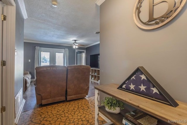 entrance foyer with visible vents, ornamental molding, a textured ceiling, french doors, and ceiling fan