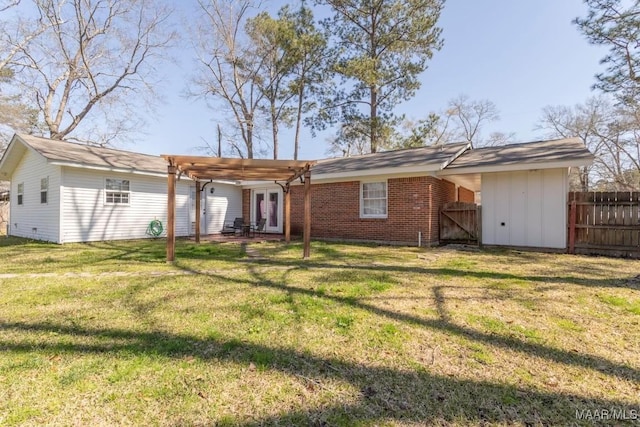 rear view of property featuring a gate, fence, a pergola, a lawn, and brick siding