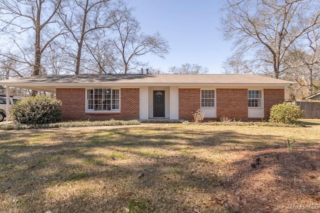 single story home with brick siding, a front yard, and fence