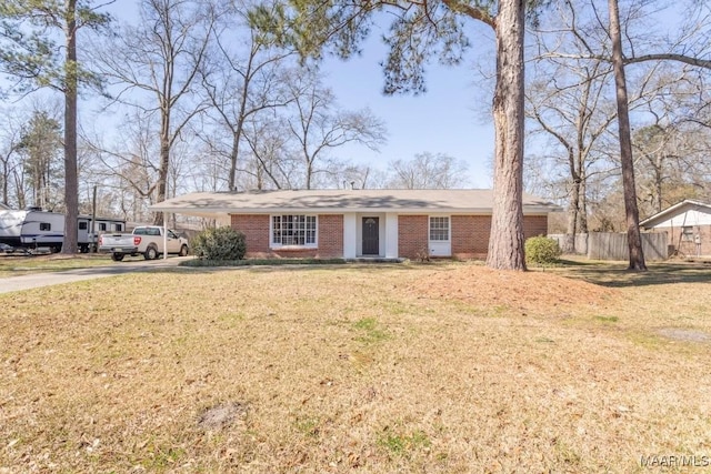 ranch-style house with driveway, brick siding, a front lawn, and fence