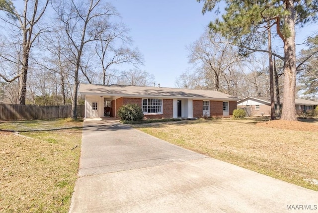 ranch-style home featuring a front lawn, driveway, an attached carport, fence, and brick siding