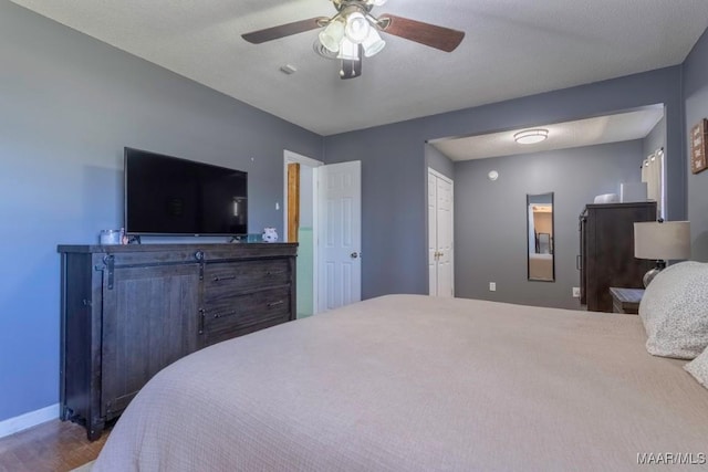 bedroom featuring baseboards and a ceiling fan