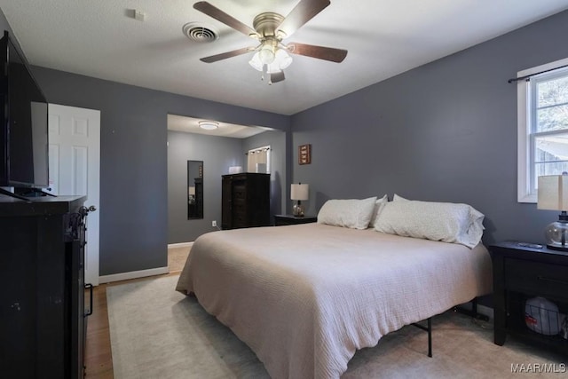 bedroom featuring visible vents, baseboards, and ceiling fan