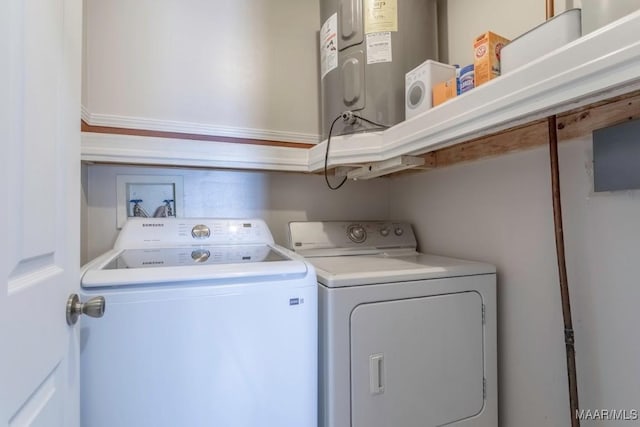 washroom featuring water heater, laundry area, and washing machine and clothes dryer