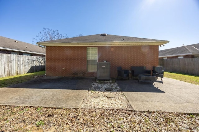 back of house with a patio area, a fenced backyard, cooling unit, and brick siding