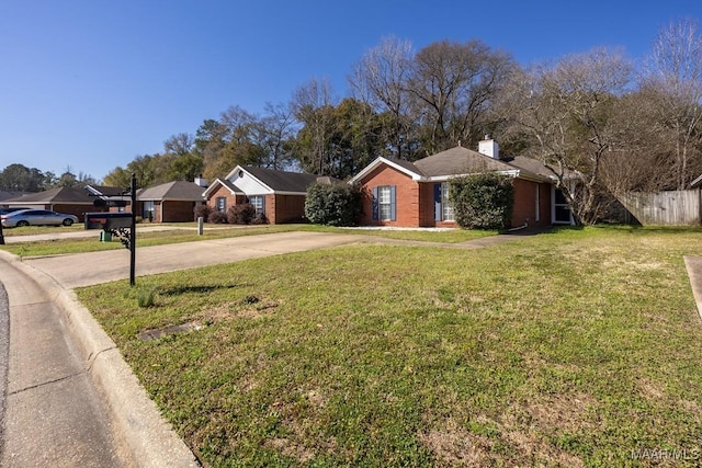 single story home with fence, driveway, a chimney, a front lawn, and brick siding