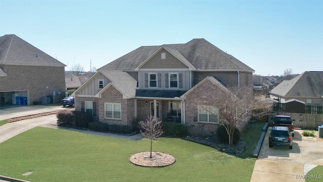 craftsman-style home with brick siding, board and batten siding, concrete driveway, and a front lawn