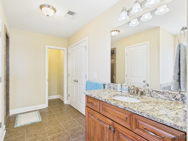 full bath with tile patterned floors, visible vents, baseboards, and vanity