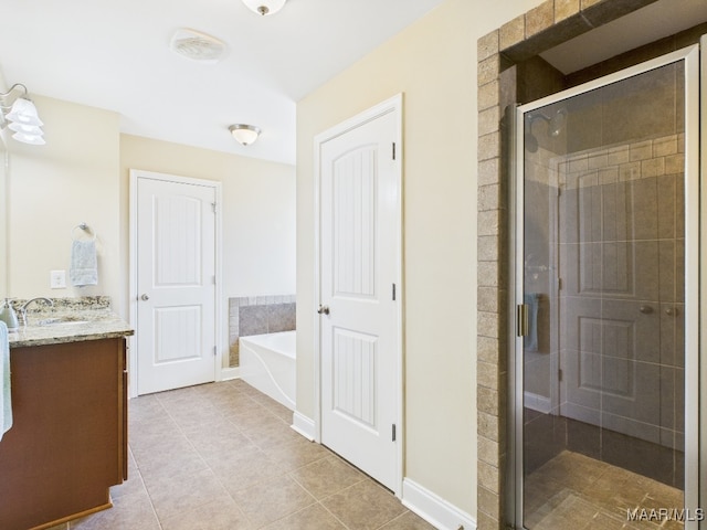 bathroom with vanity, a garden tub, a stall shower, and tile patterned flooring