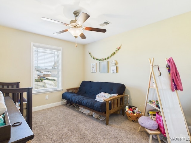 carpeted bedroom with a ceiling fan, baseboards, and visible vents