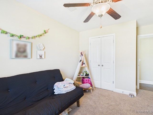 interior space with carpet flooring, a ceiling fan, and baseboards