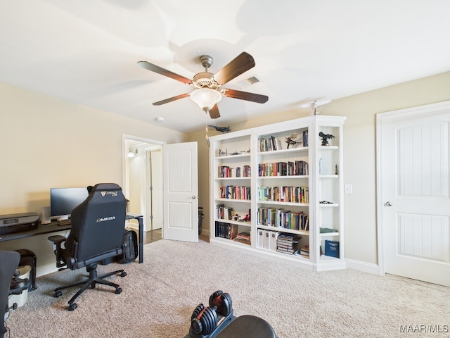 office space featuring a ceiling fan and carpet