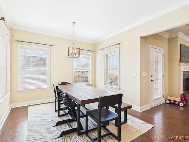 dining area with dark wood-type flooring, plenty of natural light, and ornamental molding