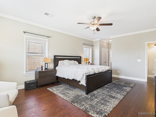 bedroom with visible vents, baseboards, dark wood-style floors, and crown molding