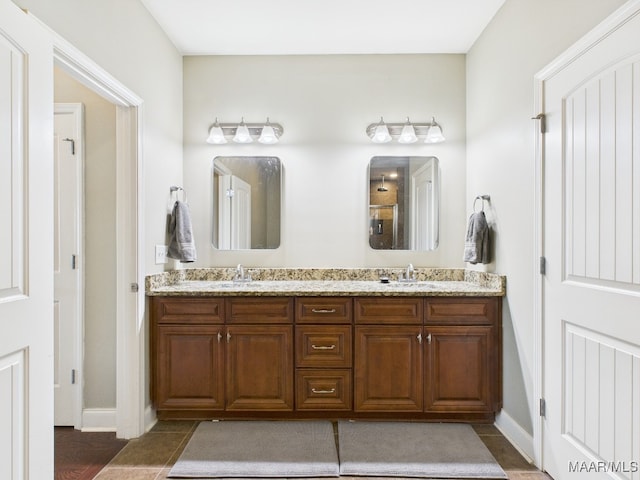 full bath with tile patterned flooring, double vanity, and a sink