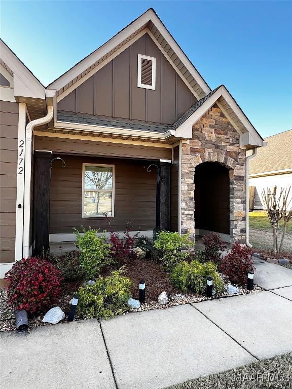 view of front of house featuring stone siding and board and batten siding