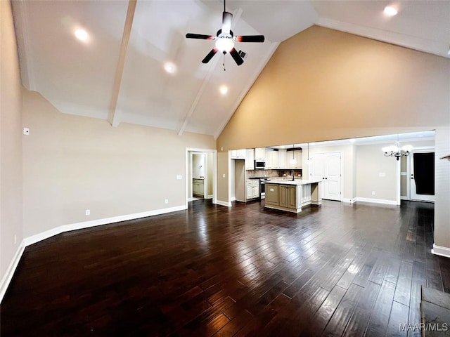 unfurnished living room with dark wood-style floors, baseboards, high vaulted ceiling, a sink, and ceiling fan with notable chandelier