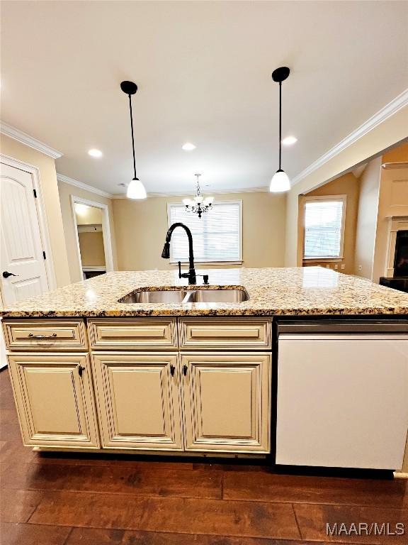 kitchen with a sink, cream cabinets, dishwasher, and ornamental molding