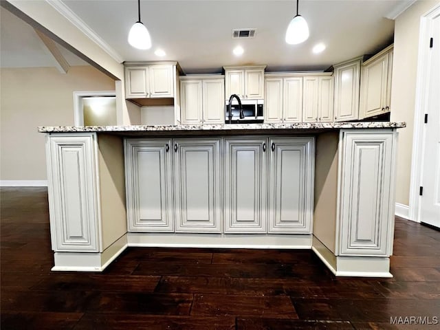 kitchen featuring hanging light fixtures, dark wood-style floors, and visible vents