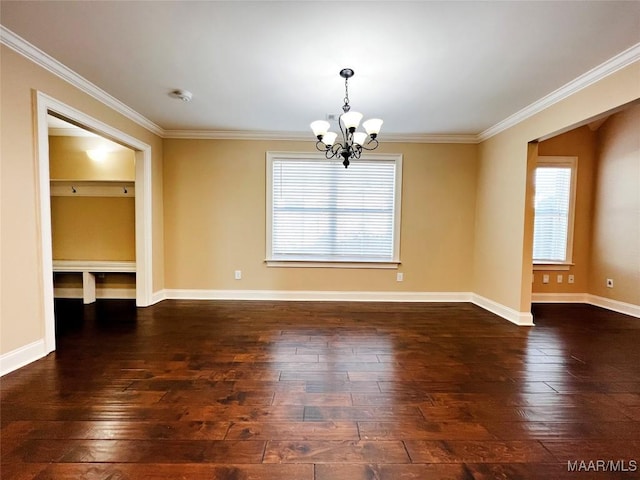 spare room featuring baseboards, dark wood-type flooring, an inviting chandelier, and crown molding