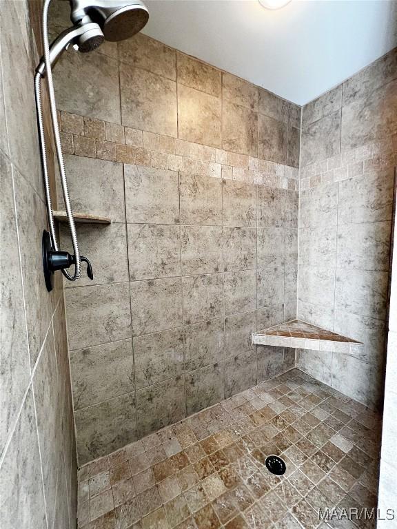 bathroom with a tile shower