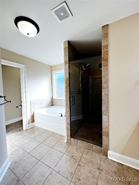 bathroom with baseboards, visible vents, tile patterned flooring, a shower stall, and a bath