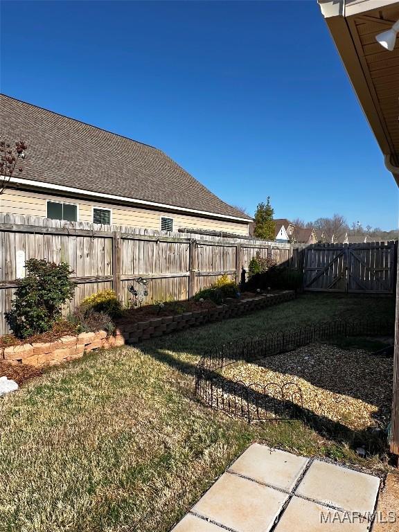 view of yard with a fenced backyard