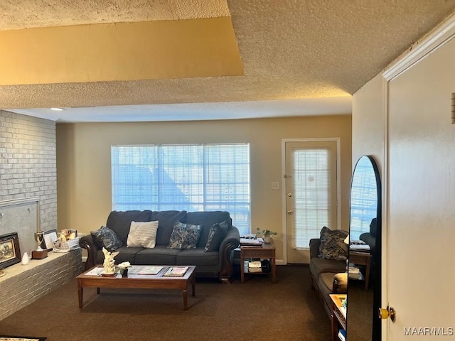 living room featuring a fireplace, dark carpet, and a textured ceiling