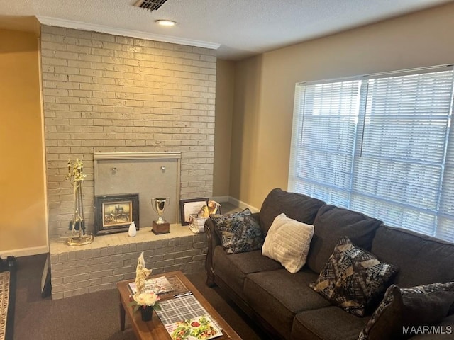 living area featuring visible vents, a fireplace, baseboards, and a textured ceiling