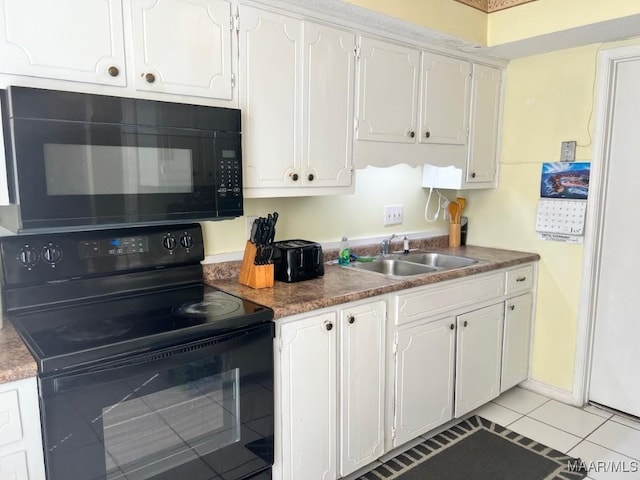 kitchen with white cabinets, black appliances, and a sink