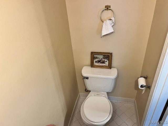 bathroom featuring toilet and baseboards