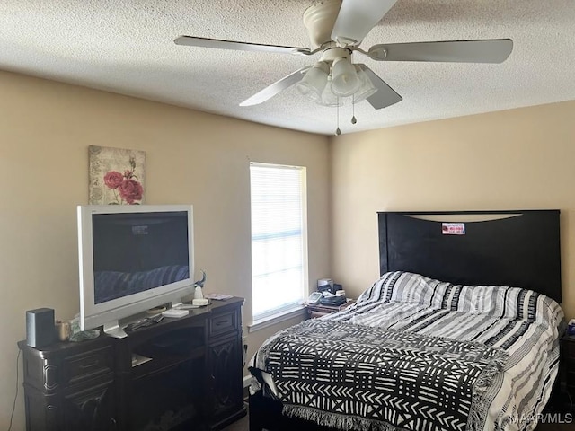 bedroom featuring a textured ceiling and a ceiling fan