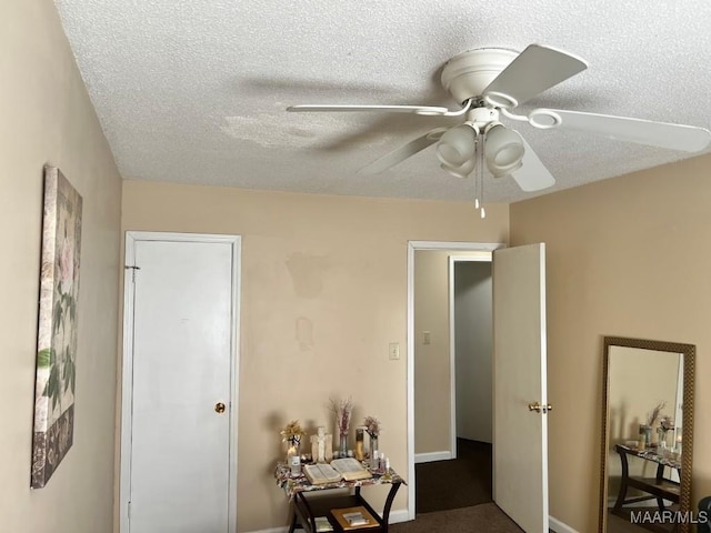 interior space with a ceiling fan and a textured ceiling