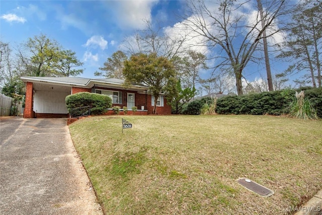 view of front of property featuring an attached carport, fence, driveway, a front lawn, and brick siding