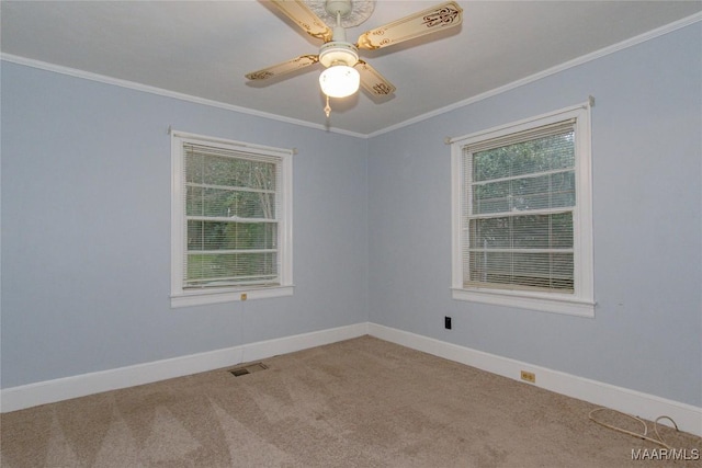 unfurnished room with visible vents, crown molding, baseboards, and carpet floors