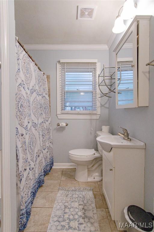 bathroom featuring vanity, visible vents, ornamental molding, tile patterned floors, and toilet