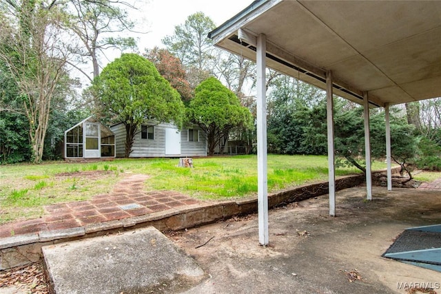 view of patio featuring an outbuilding