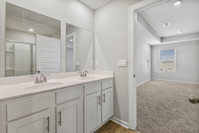 5619 Wyatt Ct, Montgomery, AL 36116 - bathroom featuring double vanity, an enclosed shower, baseboards, and a sink