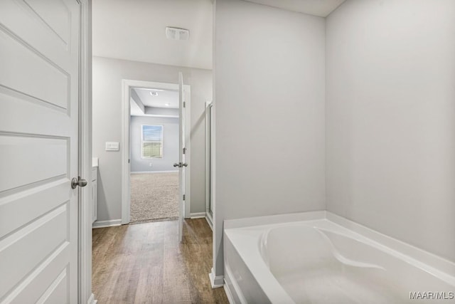5619 Wyatt Ct, Montgomery, AL 36116 - bathroom with wood finished floors, baseboards, a garden tub, and a stall shower
