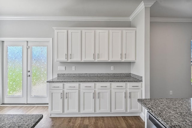 5619 Wyatt Ct, Montgomery, AL 36116 - kitchen featuring dark stone countertops, dark wood-type flooring, a healthy amount of sunlight, and white cabinets
