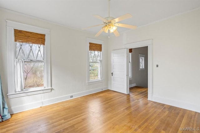 spare room with light wood-style flooring, baseboards, and ceiling fan