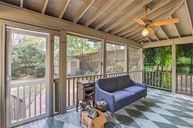 sunroom featuring ceiling fan