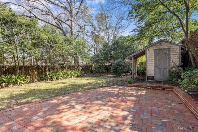 view of patio / terrace featuring a fenced backyard, a storage shed, and an outdoor structure