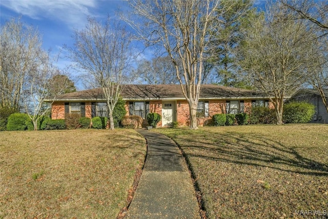 single story home featuring brick siding and a front lawn