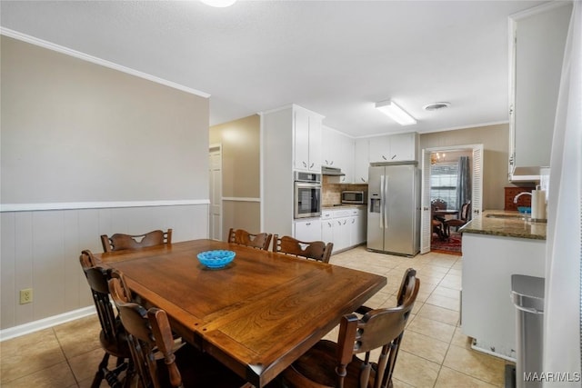 dining space featuring light tile patterned flooring, visible vents, and ornamental molding